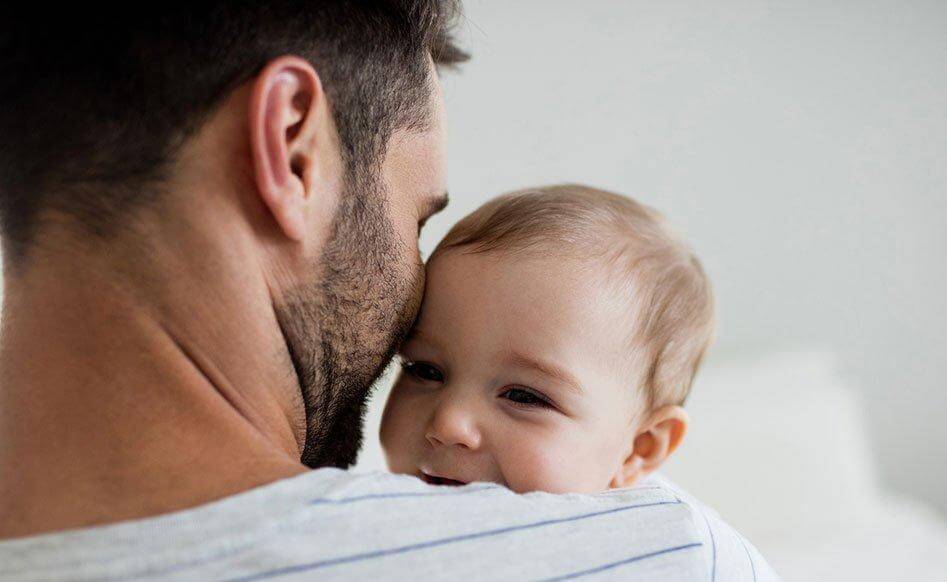 Man Holding His Smiling Baby