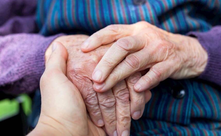 Holding Hands with Elderly Woman