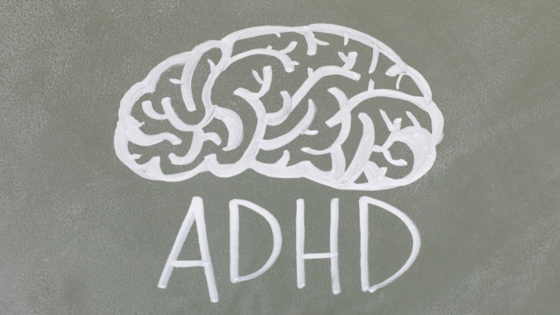 ADHD text with illustrated brain, representing attention deficit hyperactivity disorder