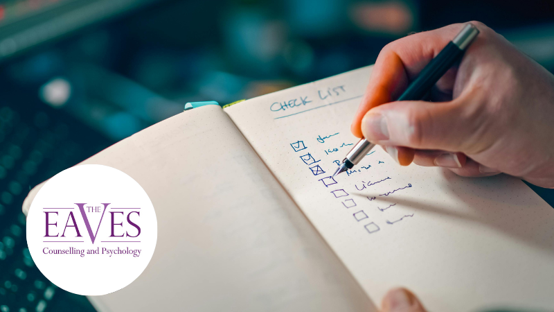 Person writing a checklist in a notebook, representing planning and support for Learning Disability Week – The Eaves Counselling and Psychology