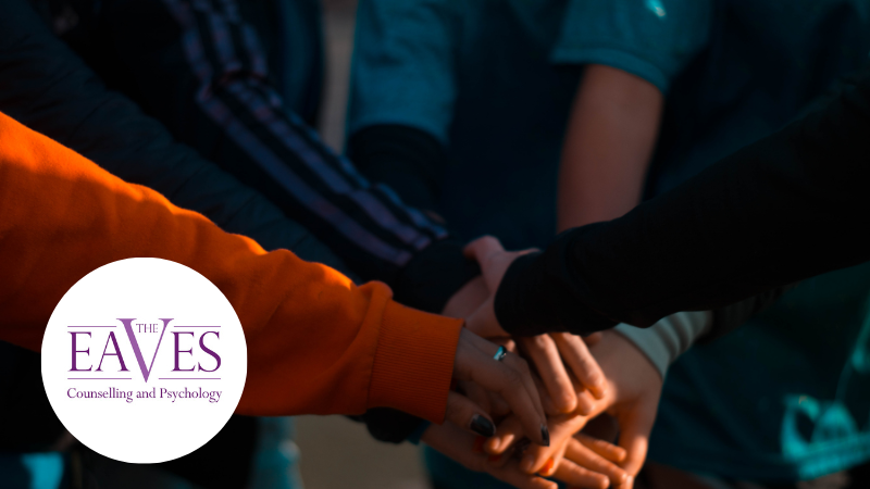 A group of people holding hands, symbolising support, connection and community for those living with dystonia