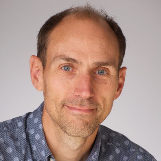Adrian Stearman, Counsellor at The Eaves in Godalming, smiling in a professional headshot.