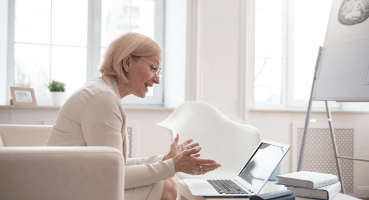 Woman sitting on sofa for online meeting