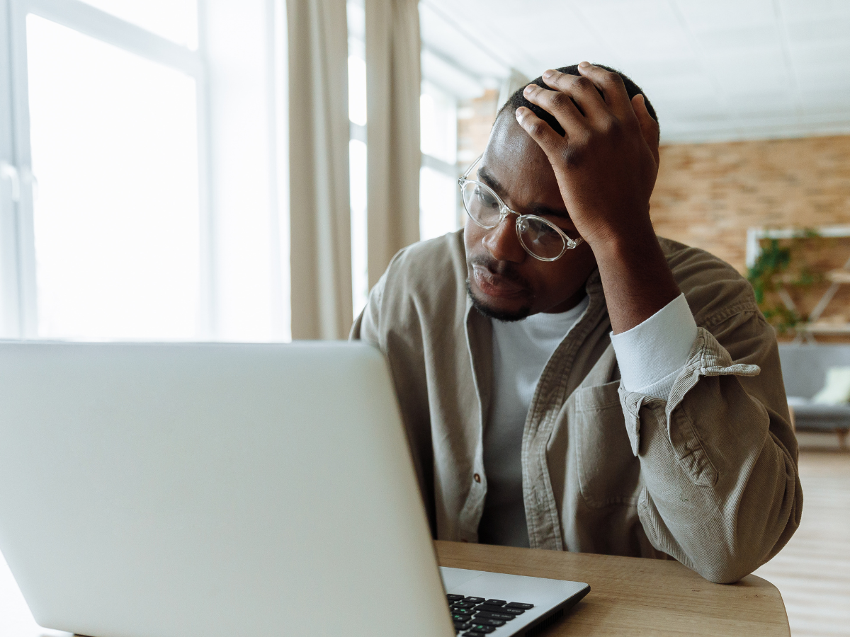 Online Therapy – man on a laptop during a virtual counselling session from home.