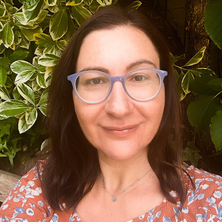 Maria Laskou, BACP Accredited Humanistic Counsellor in Farnham with brown hair and glasses.