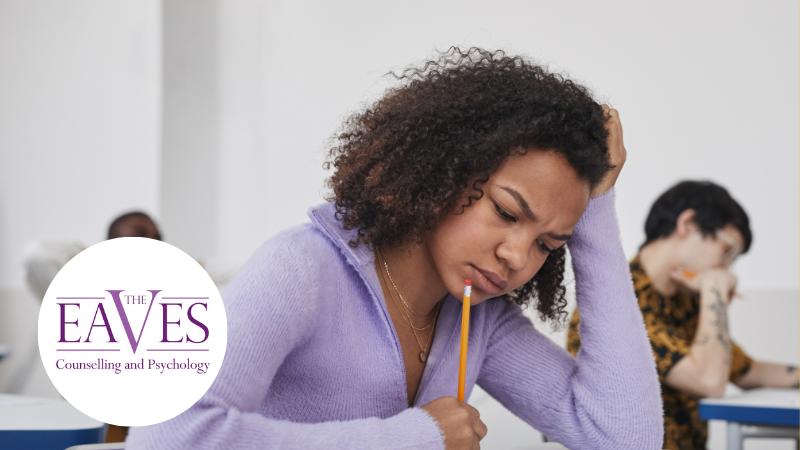 Student sitting an exam looking stressed and overwhelmed, illustrating exam stress and academic pressure on young people.