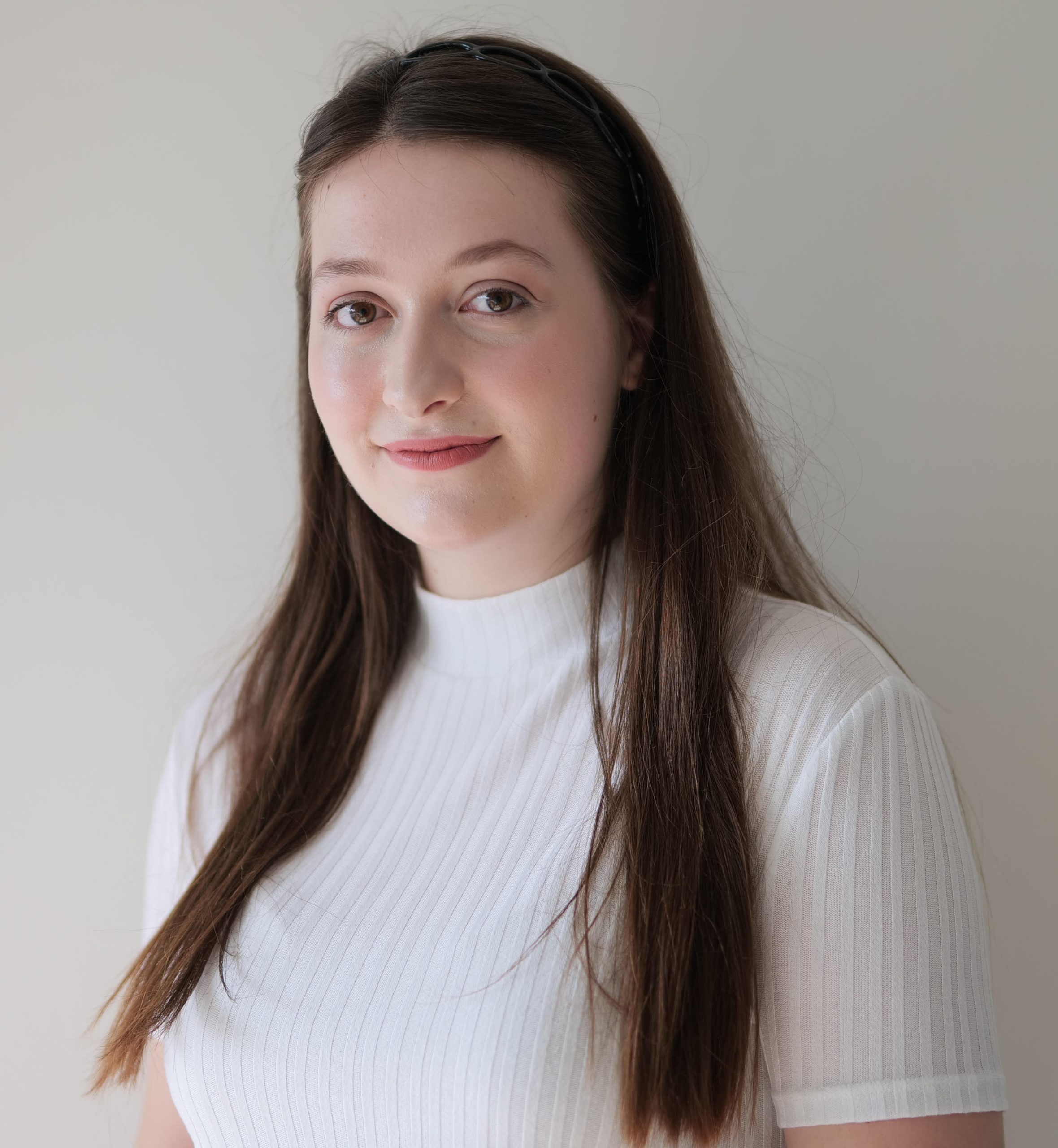 Image of Grace Parker, an integrative counsellor with long brown hair, fair skin and white turtleneck, supporting adults with learning difficulties, anxiety and burnout.