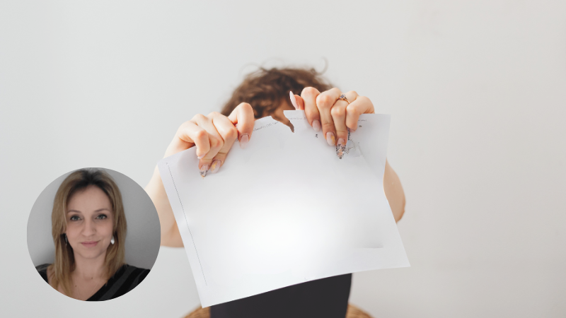 Angry woman tearing paper in front of her face, expressing strong emotions and emotional release