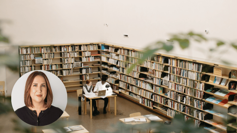 Two university students studying together in a library, representing student life, academic pressure and mental wellbeing support.