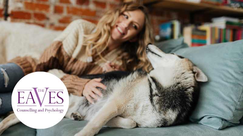 A woman cuddling her dog, showing the calming and supportive bond between humans and animals for mental health and emotional wellbeing.