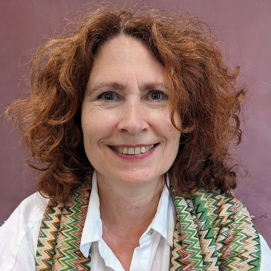Catherine Schille-Fuchs, a woman with curly red hair and a white shirt, is an integrative counsellor that works with a wide range of issues.