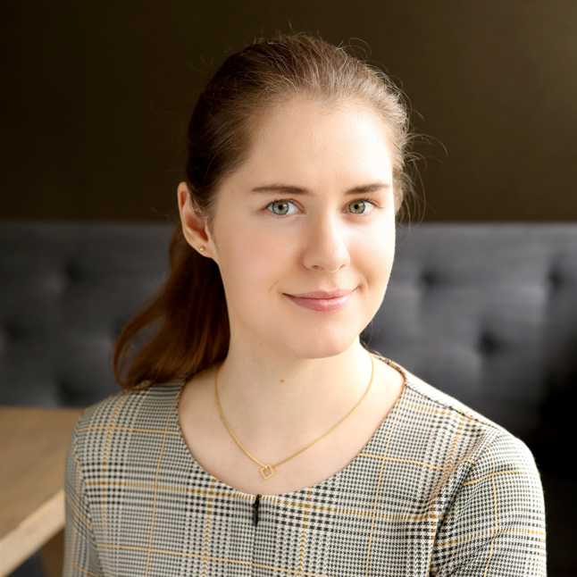 Photo of Imogen Mayhew, a counsellor and psychotherapist with brown hair, wearing a ponytail and plaid top, supporting women aged 16+ experiencing suicidal thoughts, issues with body image, perfectionism and panic attacks.