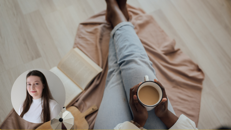 Bird’s-eye view of a woman sitting on a blanket with a cup of tea and a book, practising gentle self-care at home.