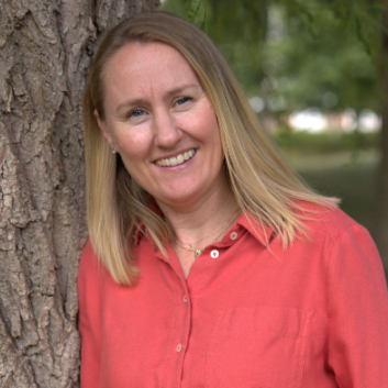 Image of Holly O'Neill, a counsellor and psychotherapist with blonde hair and a coral coloured shirt, supporting adults experiencing low self-esteem, grief, anxiety and trauma.