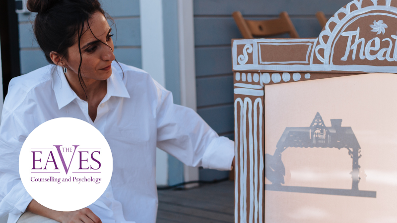 Woman watching a puppet theatre show during dramatherapy session