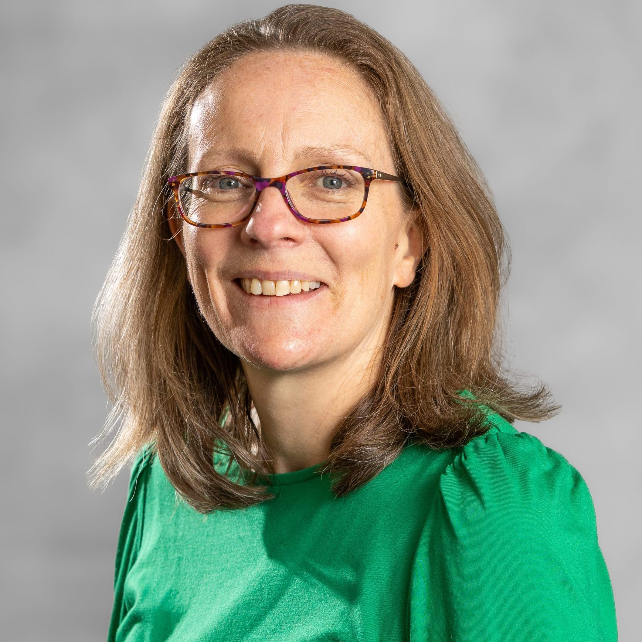 Sally Salmon is a female integrative counsellor and psychotherapist supporting adults with difficult life changes and parents of anxious children. She has shoulder length blonde hair and is wearing a green blouse.