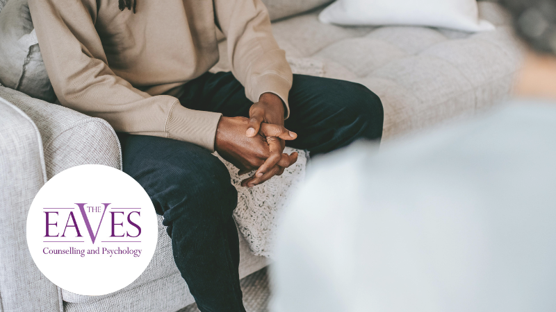 Client sitting with hands in lap during a mental health counselling session, receiving professional support for emotional well-being with The Eaves Counselling and Psychology logo