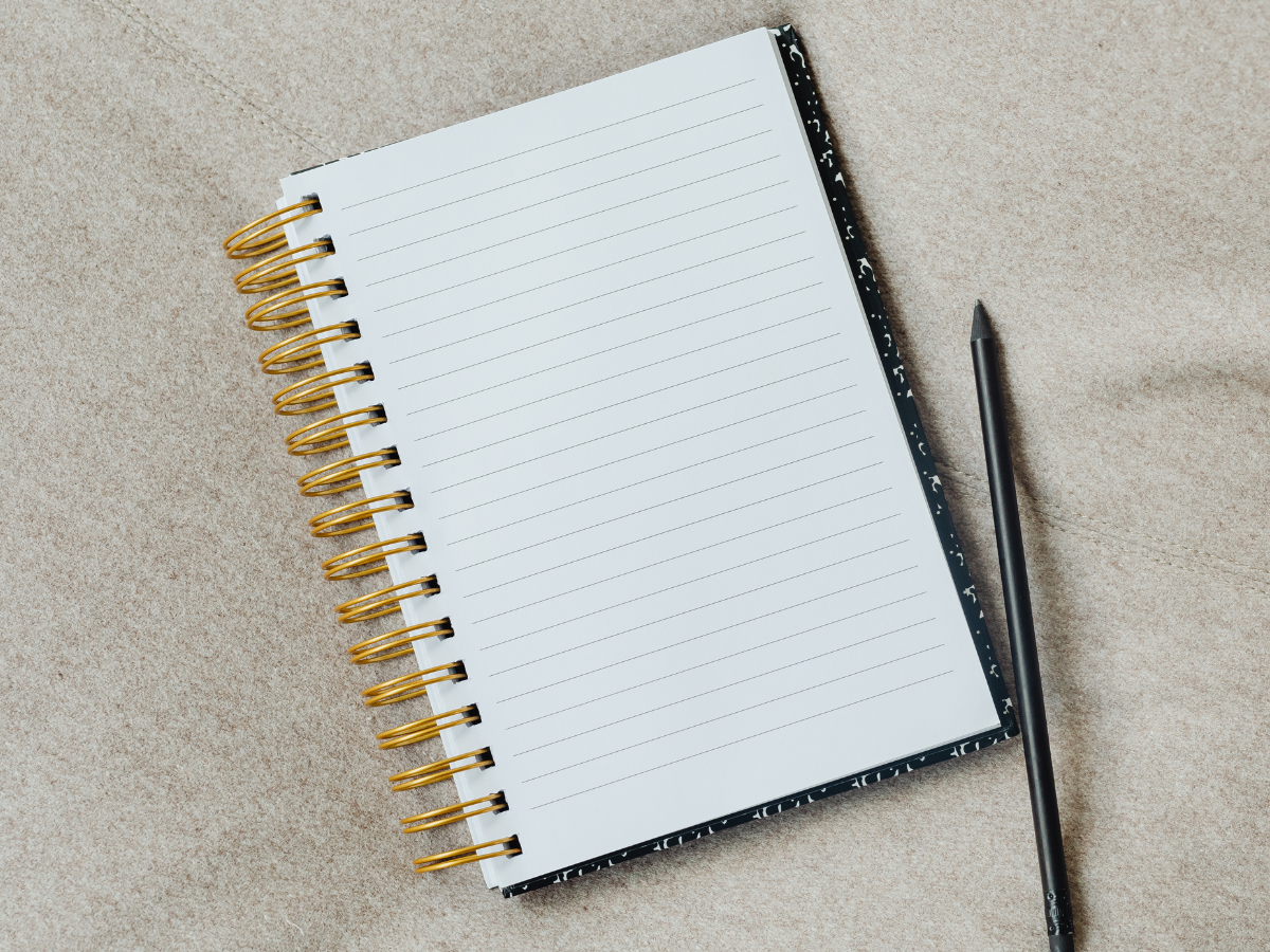Notebook and pen on a desk, symbolising planning and reflection when choosing the right mental health counsellor