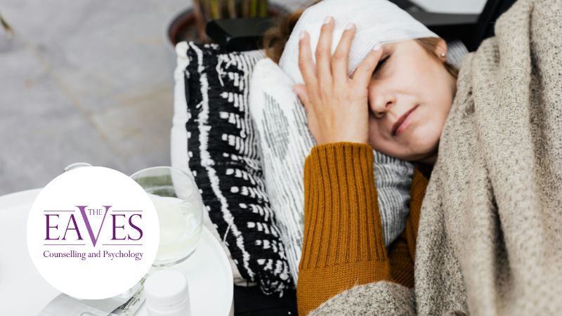 Woman resting on a sofa with a head bandage, eyes closed, with water and medication on a coffee table, representing recovery and trauma support in Surrey.