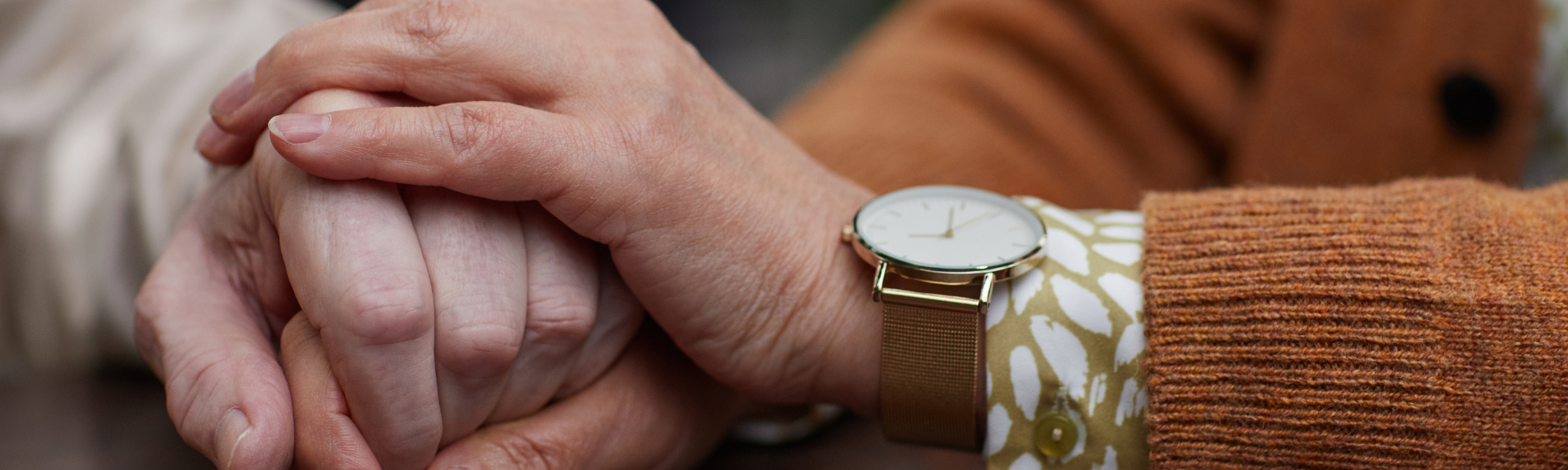Elderly couple holding hands, symbolising emotional support and mental health care for older adults in Surrey