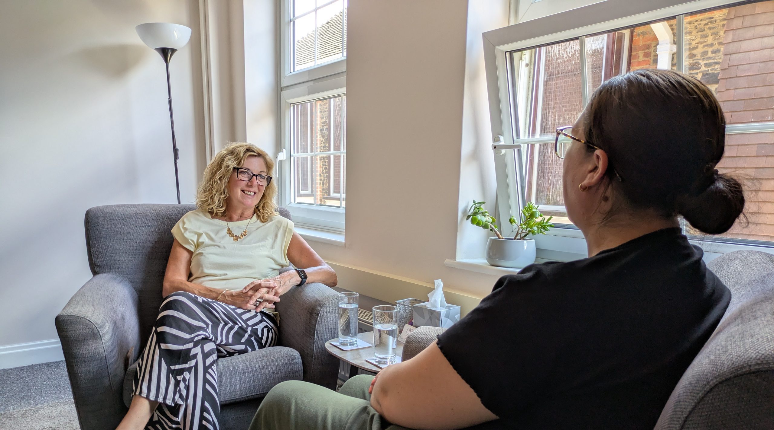 Two women seated in a calm therapy room during an affordable counselling session at The Eaves Counselling and Psychology.