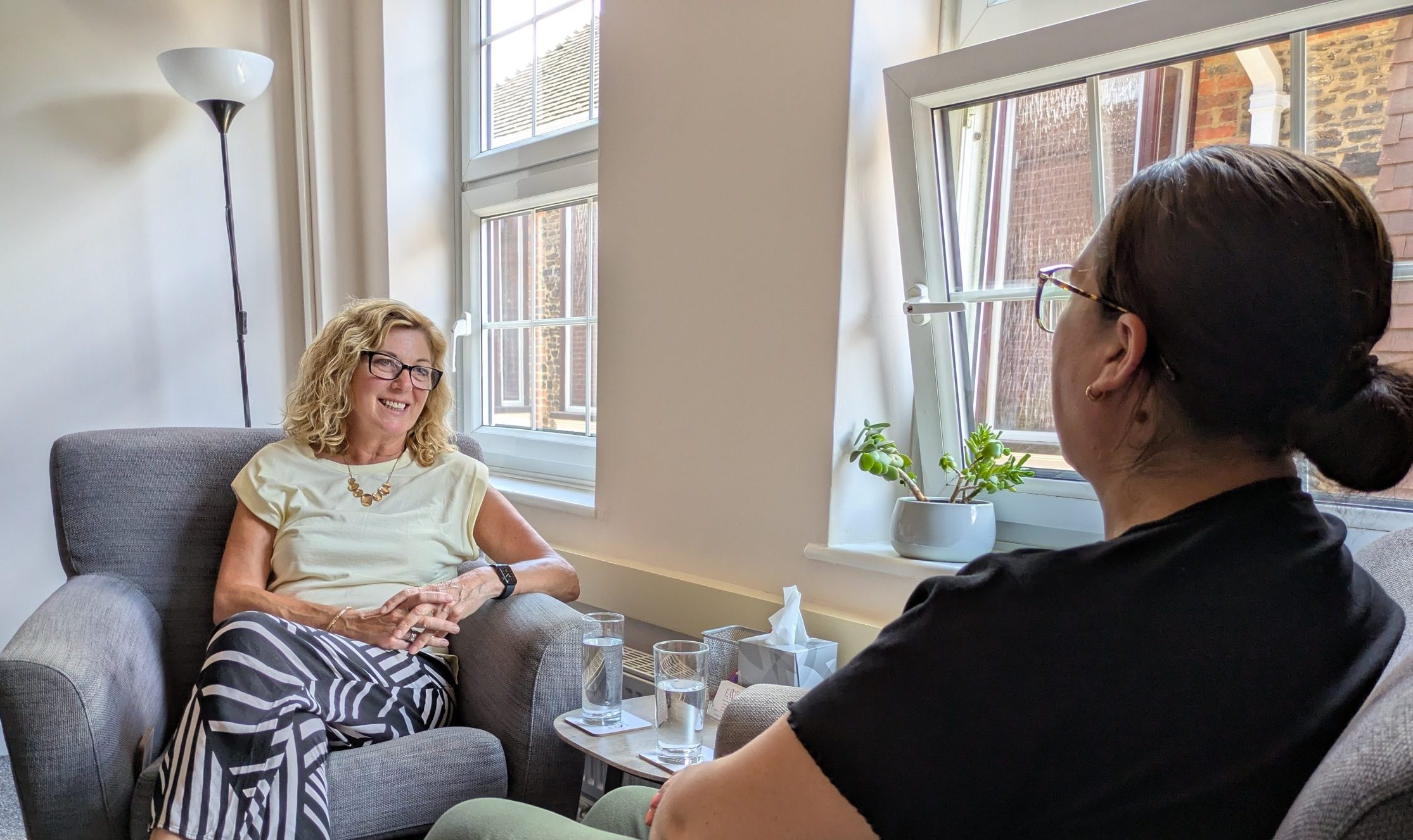 Two women seated in a calm therapy room during an affordable counselling session at The Eaves Counselling and Psychology.