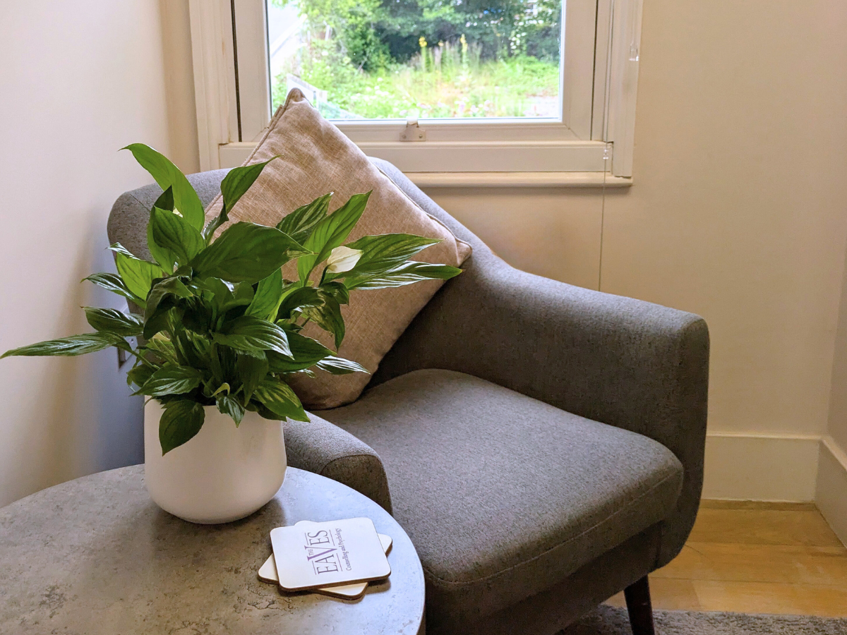 An empty chair in a quiet, welcoming therapy room, ready for a session.