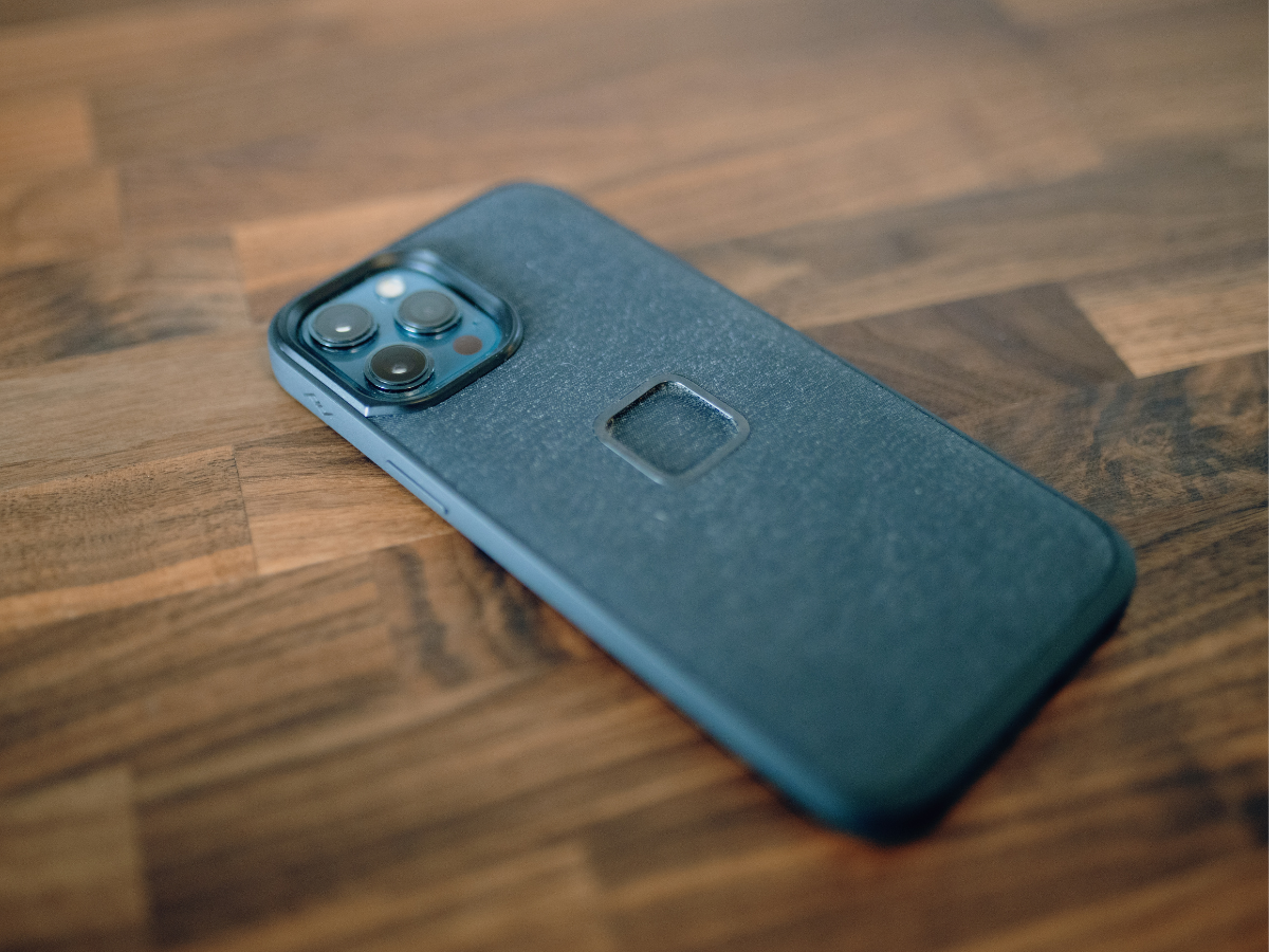 Smartphone lying face down on a wooden surface, symbolizing phone-free or screen-free time
