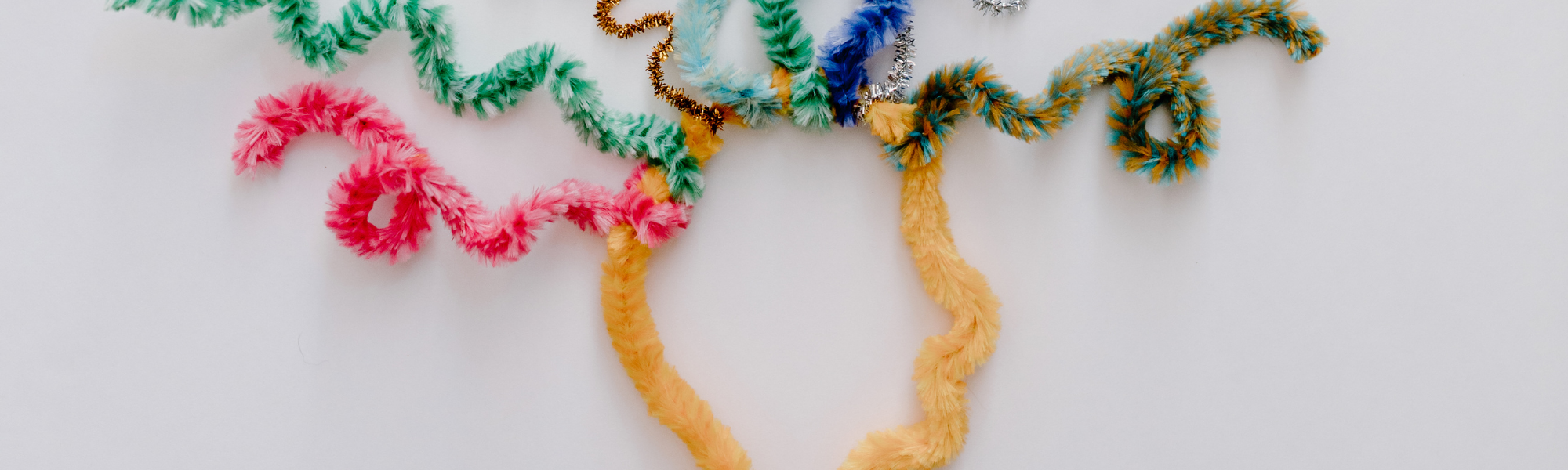 Abstract head made from yellow craft wire with colourful spiralling wires symbolising neurodivergent brain activity and diverse thinking