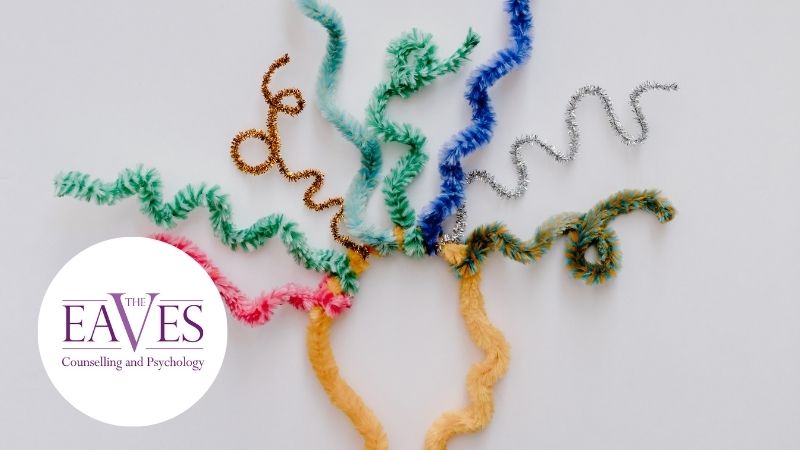 Abstract head made from yellow craft wire with colourful spiralling wires symbolising neurodivergent brain activity and diverse thinking