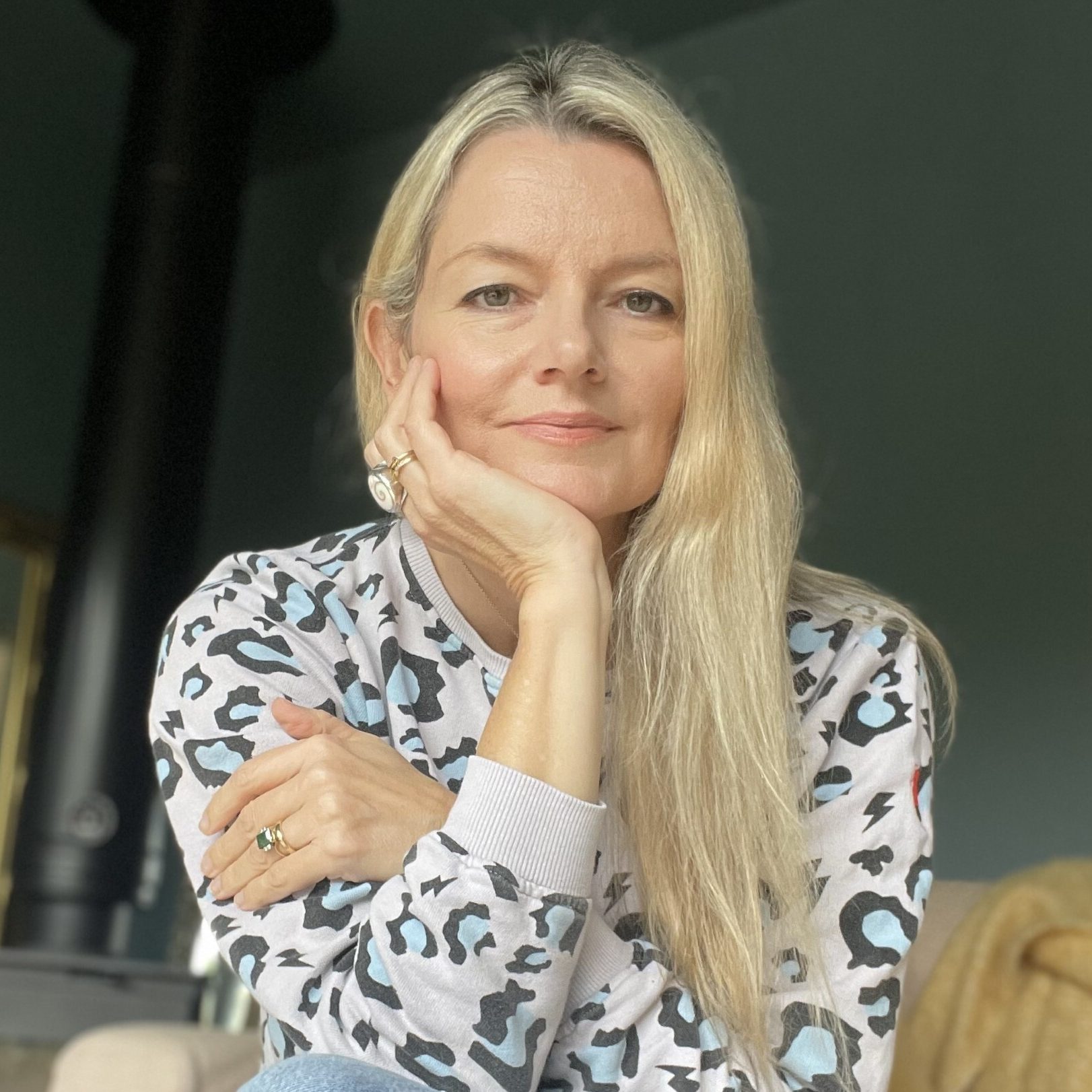 Portrait of Kate, an integrative psychotherapist, smiling warmly in a professional setting.