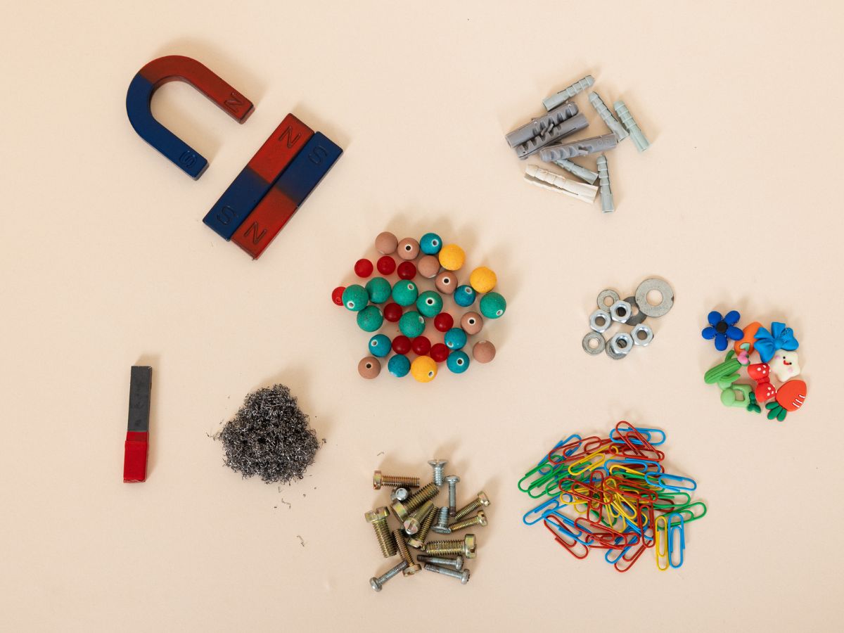 Neatly arranged everyday objects including magnets, beads, screws, and paper clips, illustrating the difference between perfectionism and obsessive compulsive disorder (OCD).