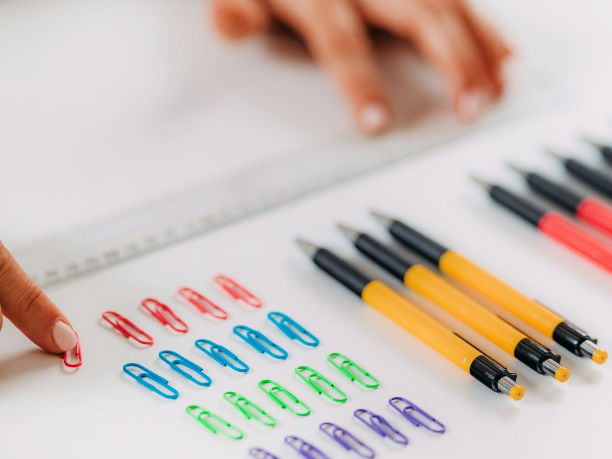 Close-up of stationery items being methodically arranged in a neat order, representing compulsive organising behaviours often linked to OCD.