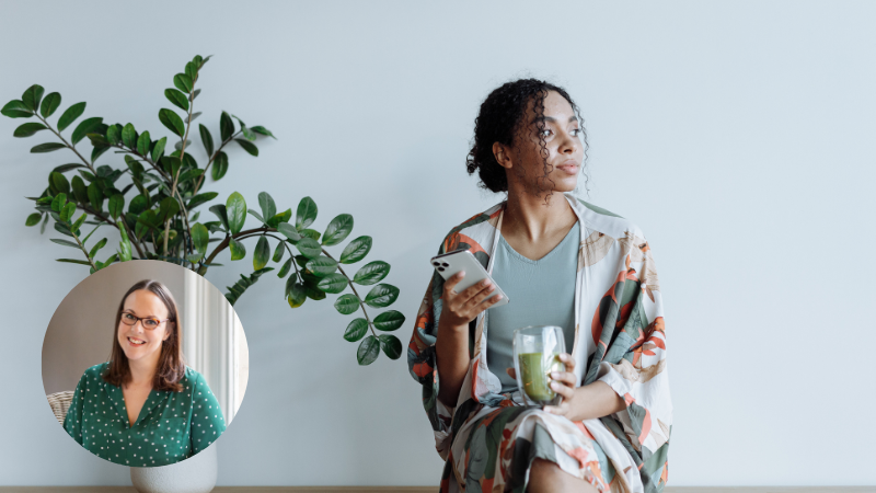 Thoughtful woman holding phone with a plant beside her, symbolising the inner struggles Aimee Bishop discusses in her blog.