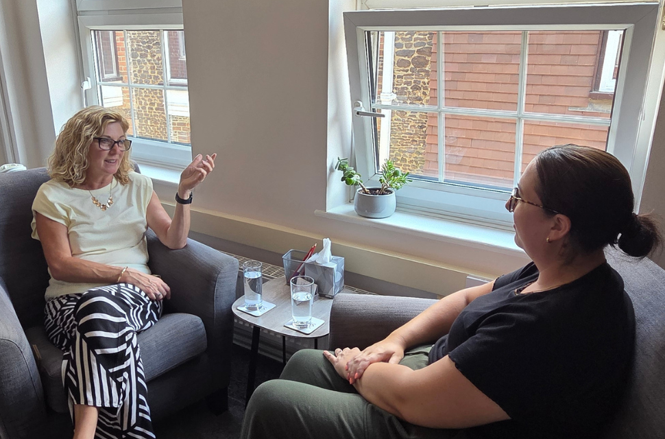 Counsellor receiving supervision in a private therapy room for professional development