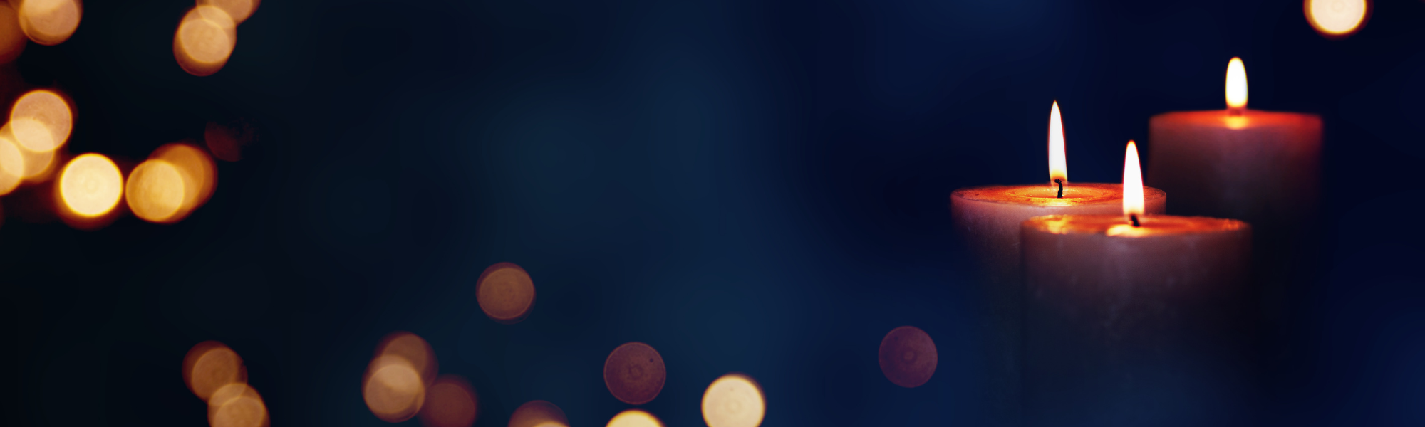 Flickering candles in the dark symbolizing remembrance, grief, and reflection.