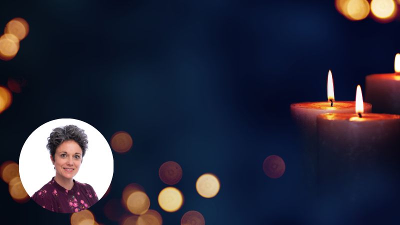 Flickering candles in the dark symbolizing remembrance, grief, and reflection.