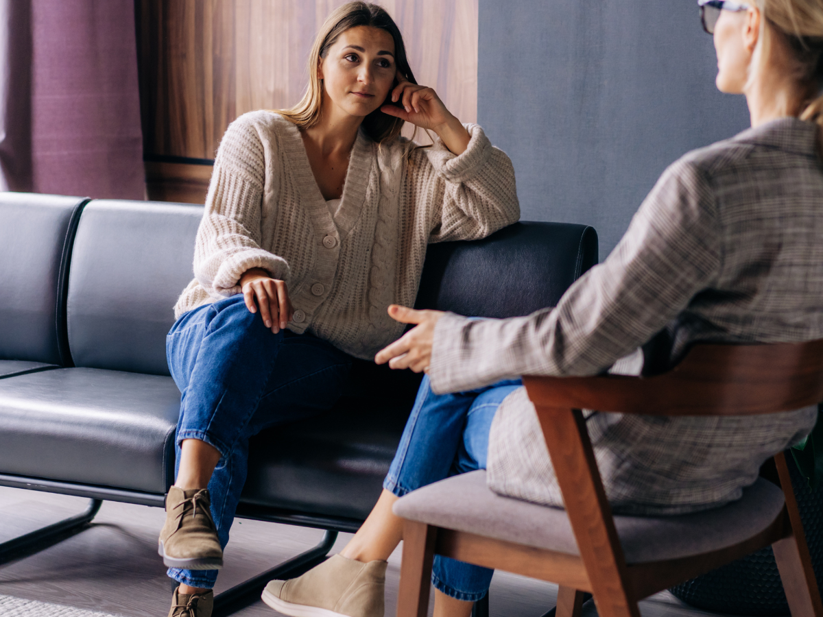 Client speaking with a therapist during a counselling session, representing emotional support and mental health care.