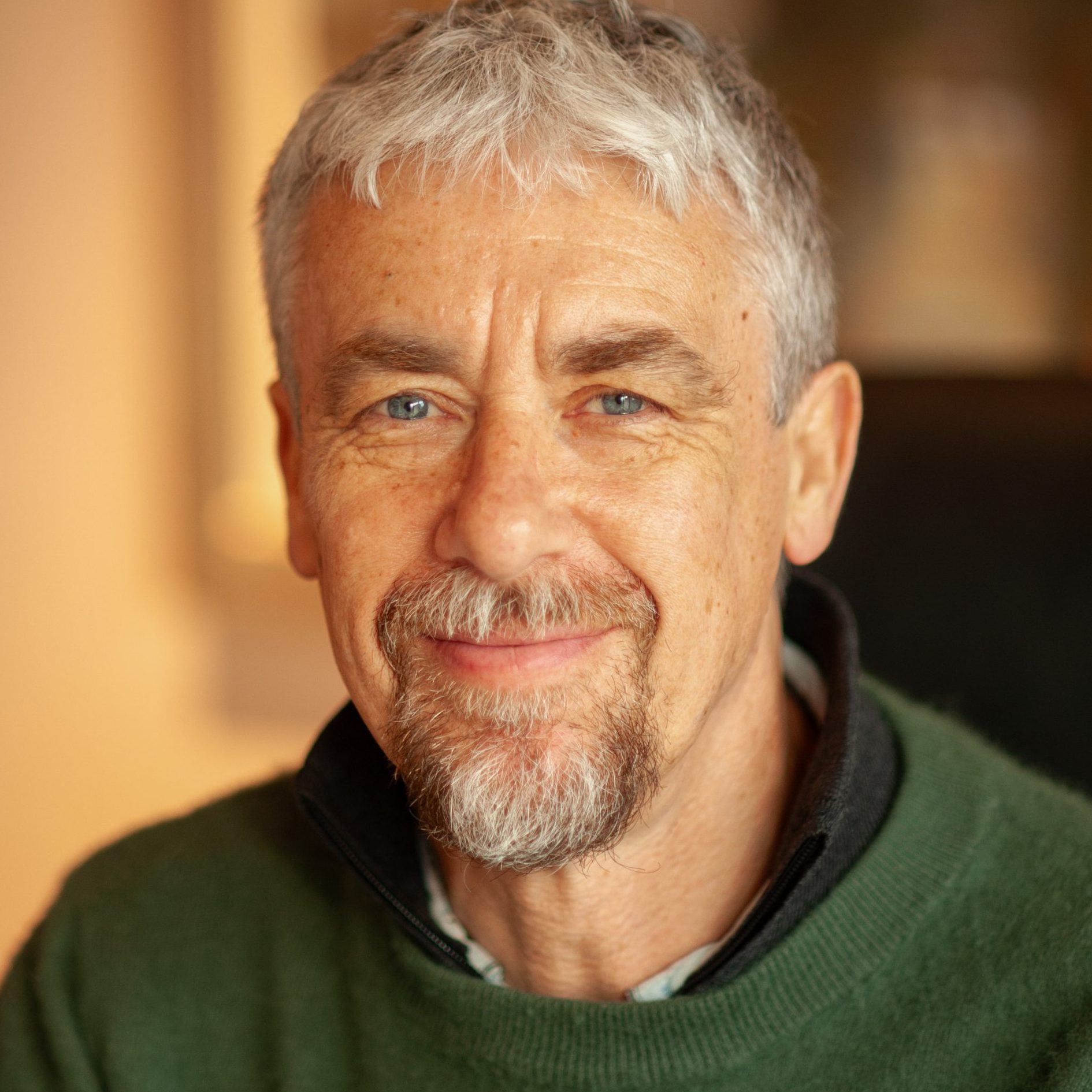 Image of Nick Grant, an integrative counsellor specialising in attachment and anxiety, a man with grey hair wearing a green sweater.
