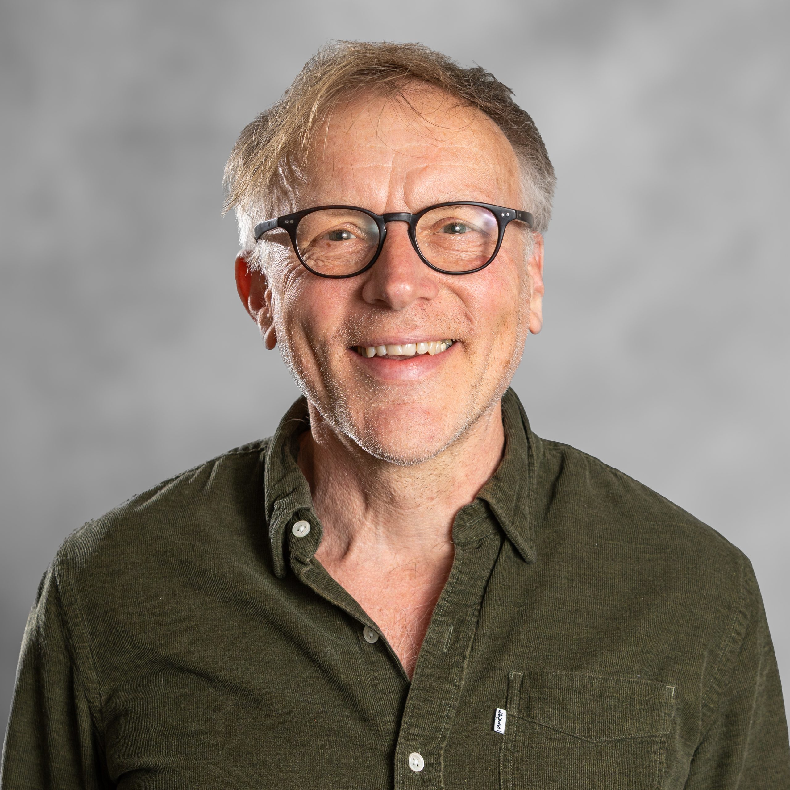 Alan Clark, counsellor with white hair, glasses and a green shirt, supporting anxiety, relationships, bereavement and self-esteem