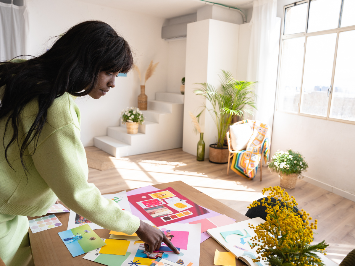Woman at desk reviewing notes, planning and scheduling her tasks