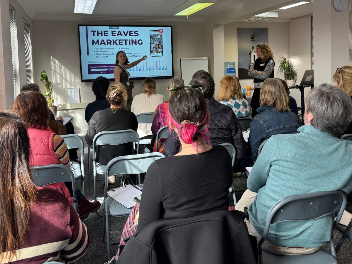 Audience attending a CPD event with two staff members presenting at the front