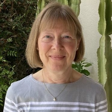 Jaqueline Bond, a woman with short blonde hair wearing a grey sweater, is a CBT therapist supporting anxiety, depression and self-esteem.