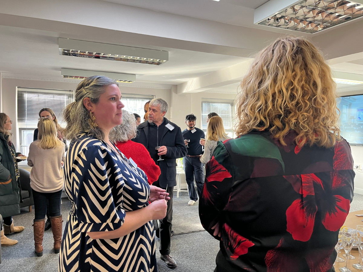 Therapists networking and mingling in a large open professional space