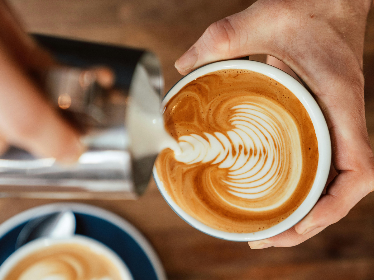 Person pouring coffee into a cup in a calm, everyday moment.