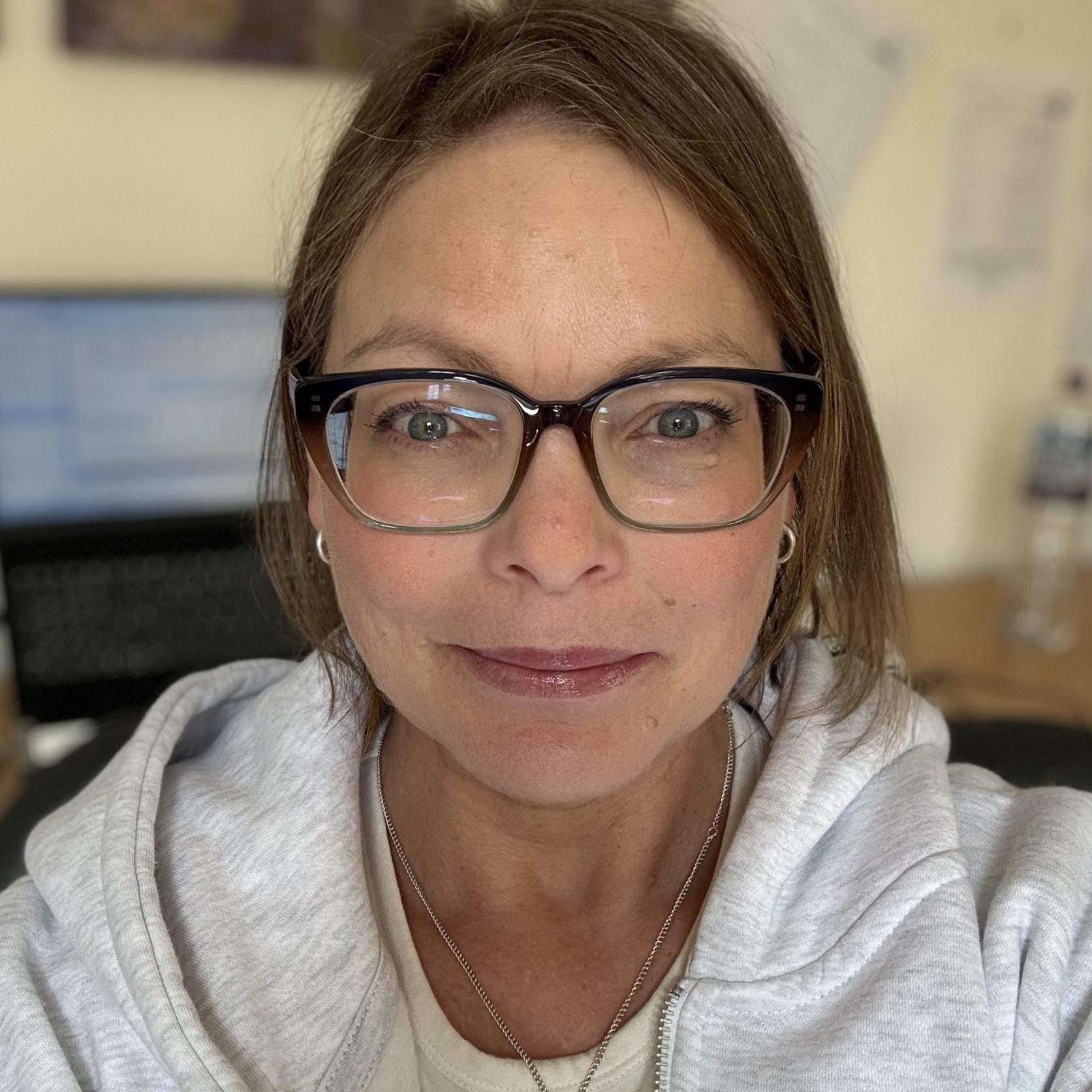 Image of Kerry Sapseid, a humanistic counsellor for adults and young people working with parents of children in the care system and addiction. She has short brown hair and glasses.