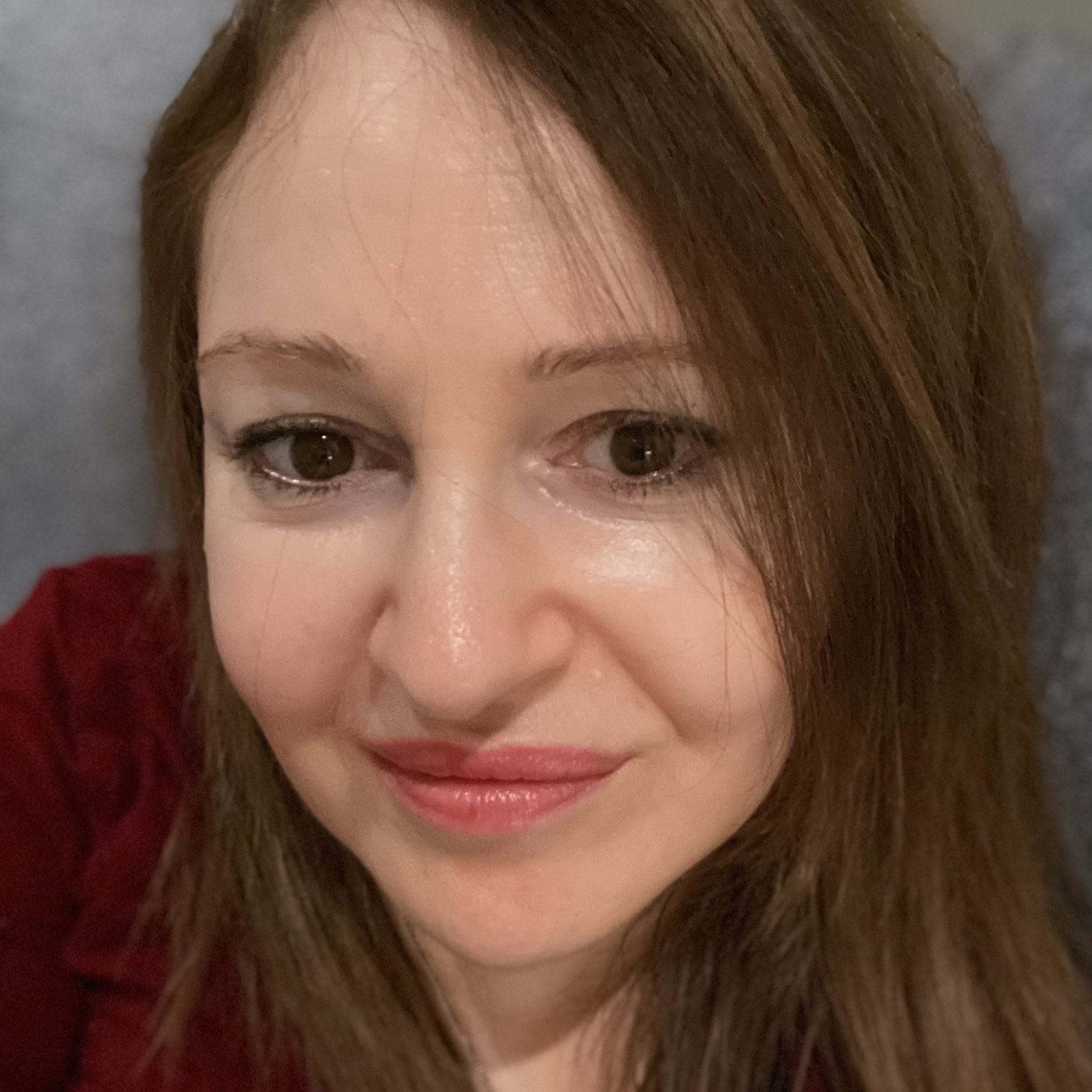 Image of Melissa Jacobs, a counsellor and psychotherapist with brown hair and wearing a red top, supports adults with anxiety, low self-esteem and workplace related issues.
