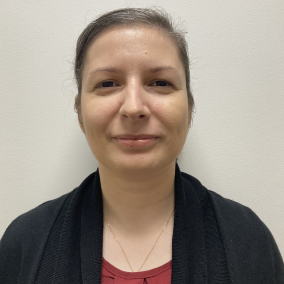 Image of Beatrice Mistretu, an integrative counsellor with short brown hair and an orange sweater.