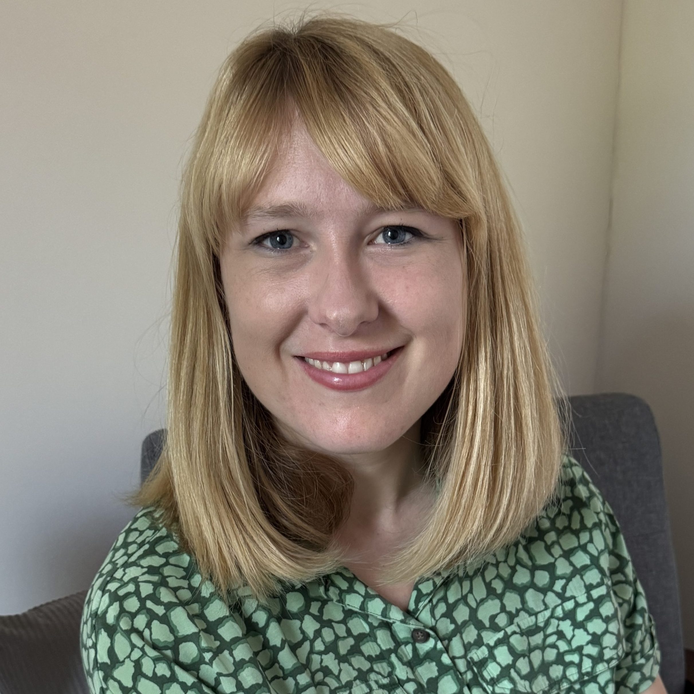 Christine Sadri-Casely, counsellor with short blonde hair and a green floral top, supporting adults with anxiety, overwhelm and stress.