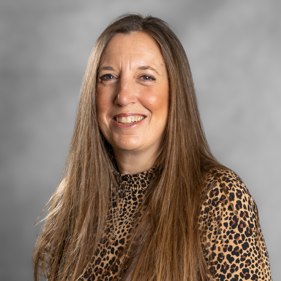 Image of Hannah Bourton, a counsellor and psychotherapist with long mousy blonde hair and a leopard print blouse.